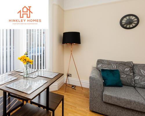a living room with a couch and a table at Supersized 5bed - Free parking - 8 beds - Anfield - By Hinkley Homes Short Lets & Serviced Accommodation in Liverpool