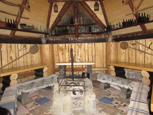 a room with wooden walls and a table and benches at Nota Bene Mykulychyn in Mykulychyn