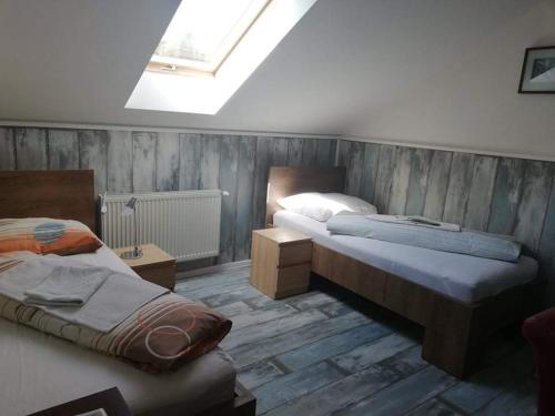a bedroom with two beds and a skylight at Twins in Hurbanovo