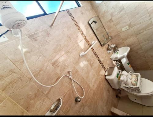 a bathroom with a shower and a toilet in a room at Suite 3B Empresarial 10Min Malecón Universidad in Guayaquil