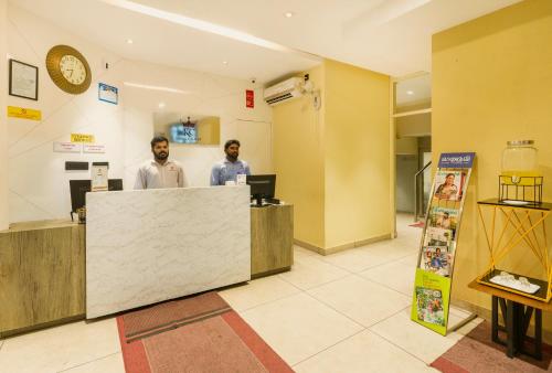 two men standing at a counter in a lobby at KINGS CALICUT in Kozhikode