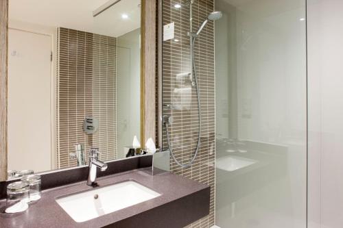 a bathroom with a sink and a glass shower at Holiday Inn York, an IHG Hotel in York