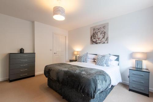 a bedroom with a large bed and two night stands at No 21 in Mansfield