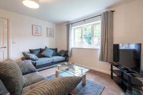 a living room with a couch and a tv at No 21 in Mansfield