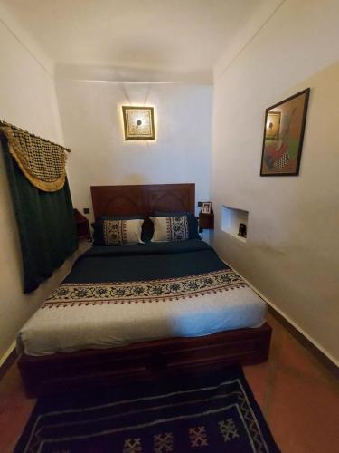 a bedroom with a bed in a room at Riad dar Karam in Marrakesh