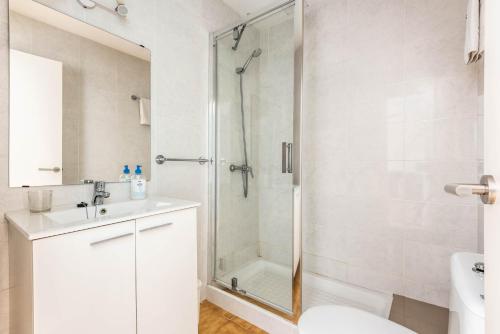 a bathroom with a shower and a sink and a toilet at Bungalows Ses Malvas in Cala en Blanes