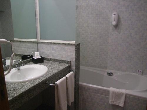 a bathroom with a sink and a bath tub at Real Ferrol in Ferrol