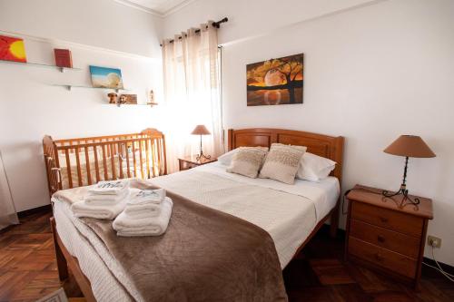 a bedroom with a bed with towels on it at TMO Residence 2 in Ponta Delgada