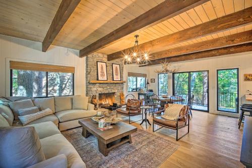 a living room with a couch and a table at Pet-Friendly Retreat with Game Room and Fire Pit! in Lake Arrowhead