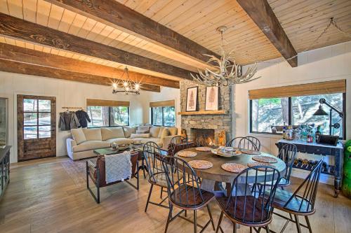 a dining room and living room with a table and chairs at Pet-Friendly Retreat with Game Room and Fire Pit! in Lake Arrowhead