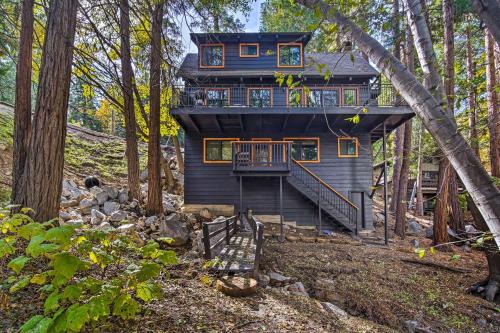 a tree house in the woods with a deck at Pet-Friendly Retreat with Game Room and Fire Pit! in Lake Arrowhead