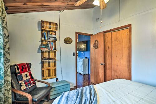 a bedroom with a bed and a chair and a book shelf at Cozy Catskills Escape, 3 Mi to Plattekill Mtn in Roxbury