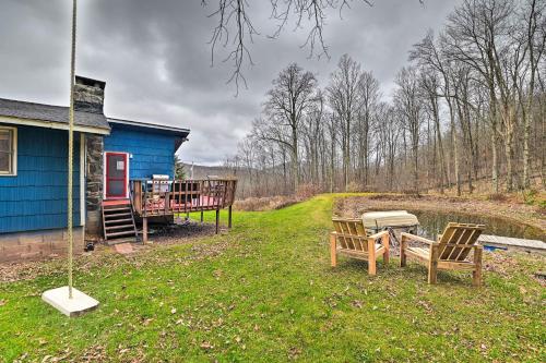 a blue house with two chairs and a grill at Cozy Catskills Escape, 3 Mi to Plattekill Mtn in Roxbury