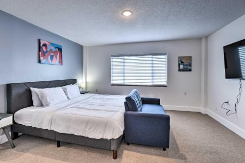a bedroom with a bed and a chair and a television at Studio in Gadsden about 10 Mi to the Coosa River! in Gadsden