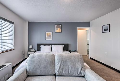 a bedroom with a large bed and a couch at Airy Apt Situated in the Coosa River Area! in Gadsden