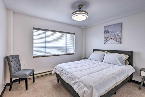 a bedroom with a bed and a chair and a window at Airy Apt Situated in the Coosa River Area! in Gadsden