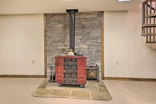 a brick fireplace with a stove in a room at Lakefront Romulus Retreat with Private Dock! in Romulus
