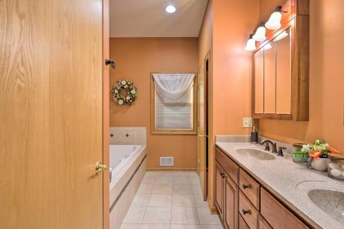 a bathroom with two sinks and a tub at Lakefront Romulus Retreat with Private Dock! in Romulus