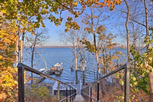 a dock with a boat in the water at Lakefront Romulus Retreat with Private Dock! in Romulus