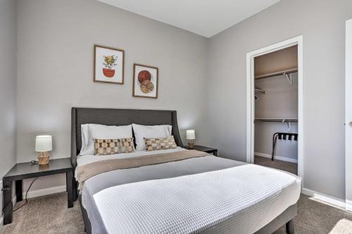 a bedroom with a large bed and two tables at 6 Mi to Dtwn Denver Townhome with Patio! in Thornton
