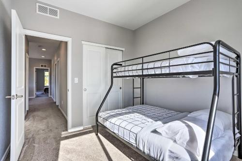 a bedroom with two bunk beds and a hallway at Commerce City Townhome about 6 Mi to Dtwn Denver! in Thornton