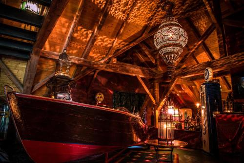 a large room with a boat and a chandelier at Bijou Hotel / Love and Romance in Kallnach