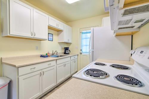 a kitchen with a stove and a refrigerator at Winchester Bay Apt Near Dunes and State Parks! in Reedsport