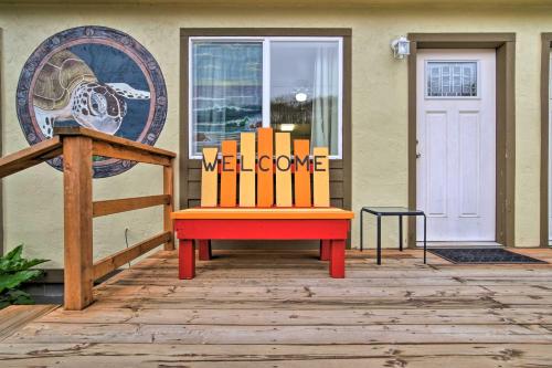a red and orange bench sitting in front of a door at Winchester Bay Apt Near Dunes and State Parks! in Reedsport