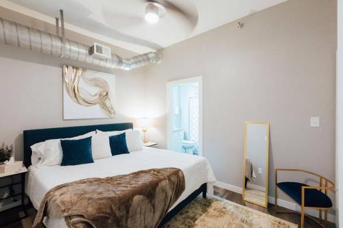 a bedroom with a large bed and a mirror at The Sanctuary Company Johnson City in Johnson City