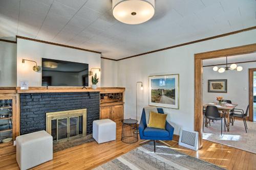 a living room with a fireplace and a table at Family-Friendly Des Moines Retreat with Patio! in Des Moines