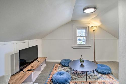 a living room with a table and a tv at Family-Friendly Des Moines Retreat with Patio! in Des Moines