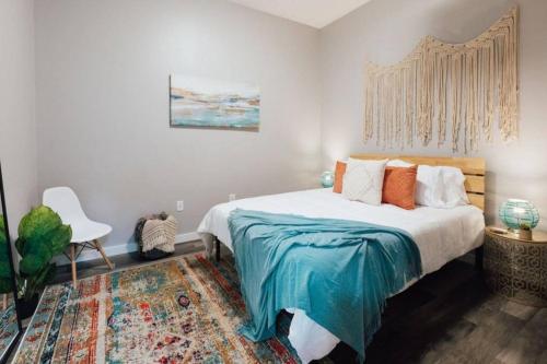 a bedroom with a bed with a blue blanket at The Sanctuary Company Johnson City in Johnson City