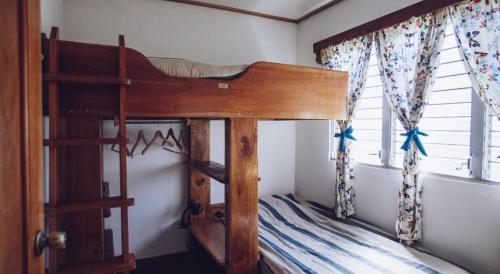 a bunk bed in a room with a window at Spanish by the River - Boquete in Boquete