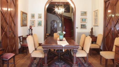 a dining room with a wooden table and chairs at Hotel Villa Maria in Sanremo