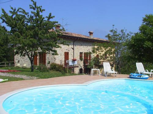 a house with a large swimming pool in front of it at Casale di Pegol in Tignale