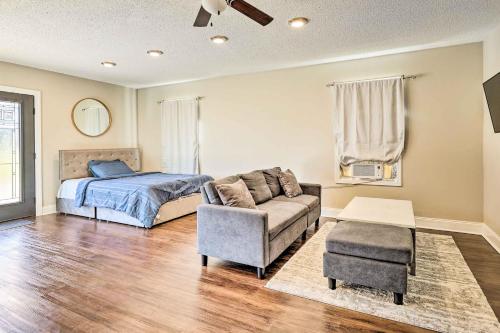 a bedroom with a bed and a couch and a chair at Modest Huntsville Studio with Full Kitchen! in Huntsville