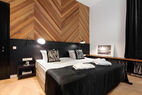 a bedroom with a large bed with two towels on it at Vytautas Mineral SPA in Birštonas