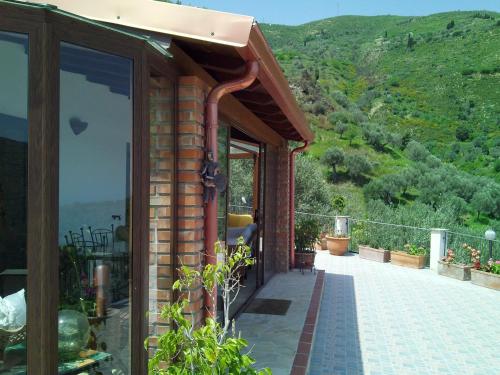a house with a balcony with a view of a mountain at La Finestra sulle Eolie in Reitano