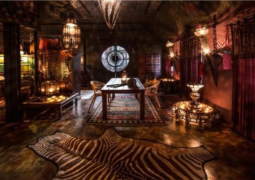 a room with a table and a zebra rug on the floor at Bijou Hotel / Love and Romance in Kallnach