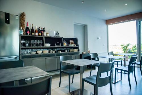 a restaurant with tables and chairs and wine bottles at FORESTERIA LOMBARDA BED and BIKE CREMONA in Crotta dʼAdda