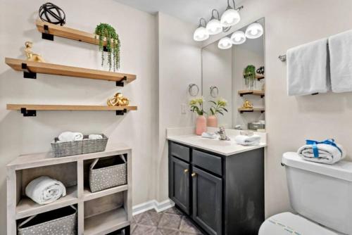 a bathroom with a sink and a mirror at 5 Star Resort 6th fl 2BR 2 BATH King Suite Shuttle Pools, restaurants & more in Destin