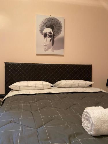 a bedroom with a bed with a picture on the wall at La Divina in Cosenza
