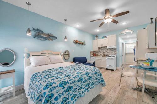 a bedroom with a bed with a blue wall at Picturesque Waterfront Studio in Clearwater Beach