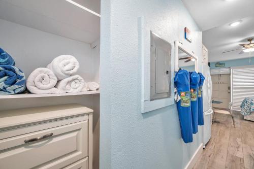 a walk in closet with a refrigerator and towels at Picturesque Waterfront Studio in Clearwater Beach