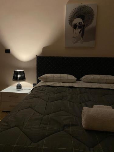 a bedroom with a bed with a black comforter at La Divina in Cosenza