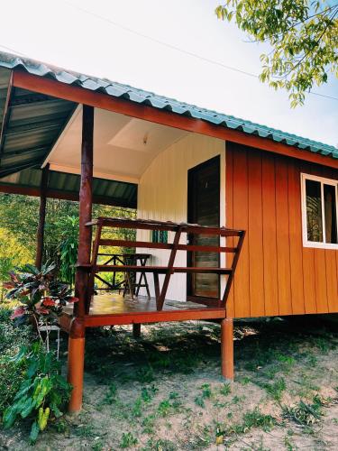 a small house with a bench in front of it at LONELY GROOVE in Ko Chang