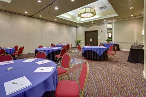 a conference room with blue tables and red chairs at Holiday Inn Staunton Conference Center by IHG in Staunton