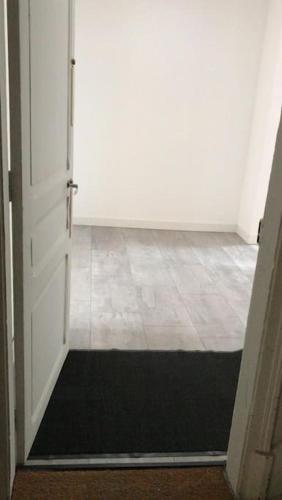 an open door with a black mat in a room at LA MAISON POURRIE in Pont-à-Mousson
