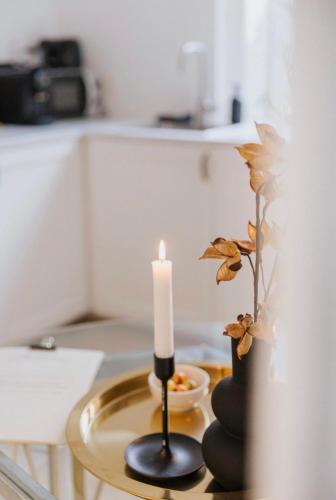 a candle sitting on a table with a bowl of fruit at Au Numéro 5 in Tilff