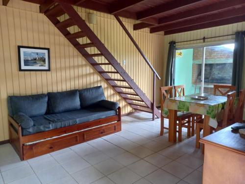 a living room with a couch and a table at Paso del.Sol in Piriápolis